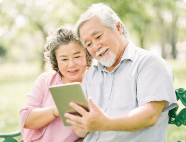 A happily married couple checking facts for the Best Cataract Surgeons