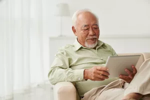 Older man reading without glasses after eye surgery