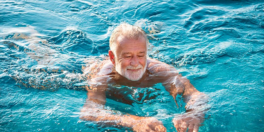 Elderly man swimming and exercising after cataract surgery